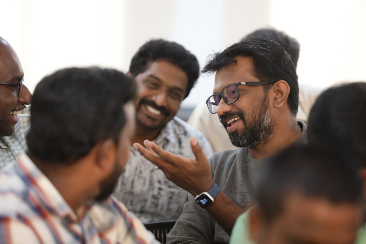 A group of 21 Day Challenge community members talking and laughing together.